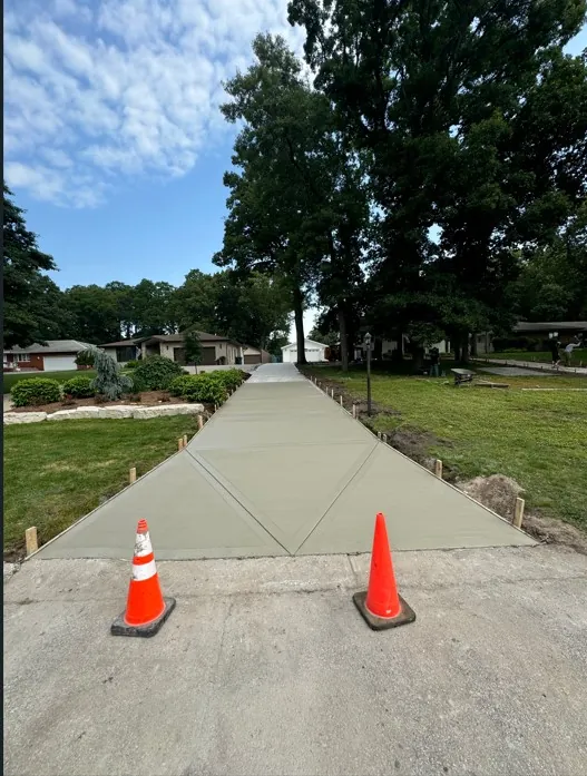 Wide residential concrete driveway walkway with decorative border pattern