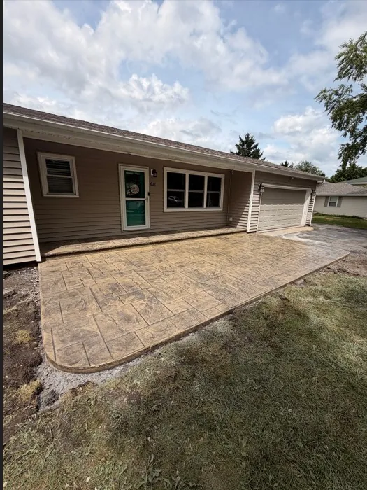 Stamped concrete patio and driveway apron in a natural stone pattern